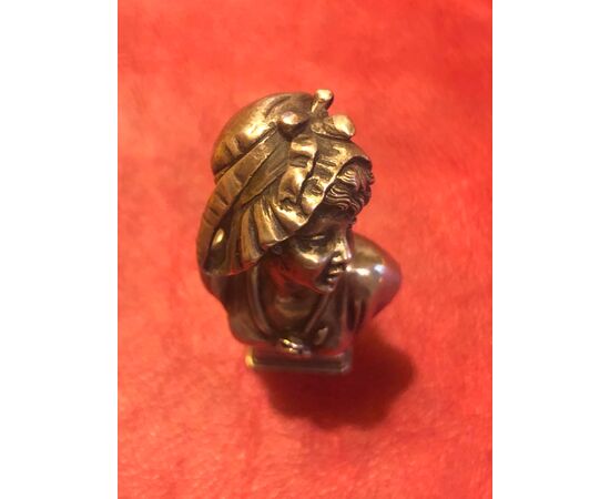 Silver seal depicting a female bust in art-nouveau style.     