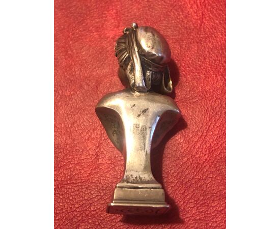 Silver seal depicting a female bust in art-nouveau style.     