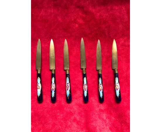 Set of six metal and enamel knives with trophy decorations.     