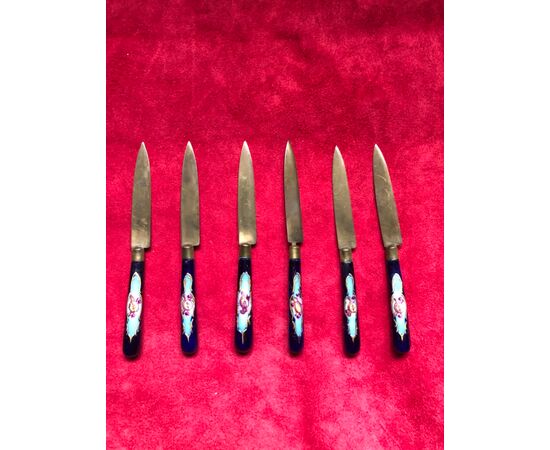 Set of six metal and enamel knives with trophy decorations.     