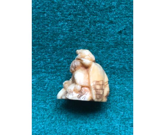Ivory netsuke &#39;with seated figure and child with frog on his head.Japan.     
