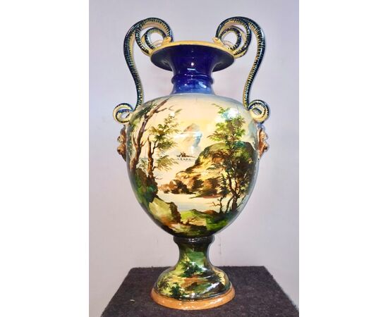 Large majolica vase with snake and mascaron handles and historiated decoration.Painter Eliseo Bertazzoni.Molaroni Manufacture, Pesaro.     