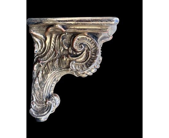 Terracotta shelf with rocaille decorations in relief with silver galvanic bath.Dini and Cellai.Signa manufacture.     