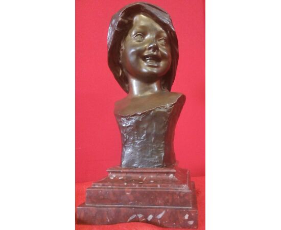 Face of a smiling girl in signed Bronze