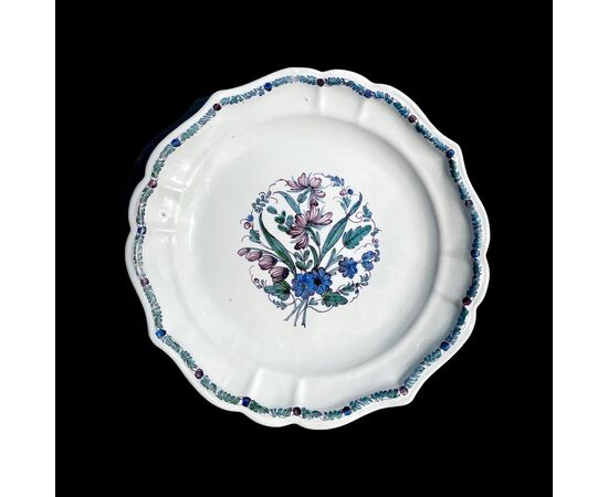 Three majolica plates with lobed brim and floral motif in the cavetto known as &#39;cut flowers&#39;. Antonibon Manufacture, Nove di Bassano.     