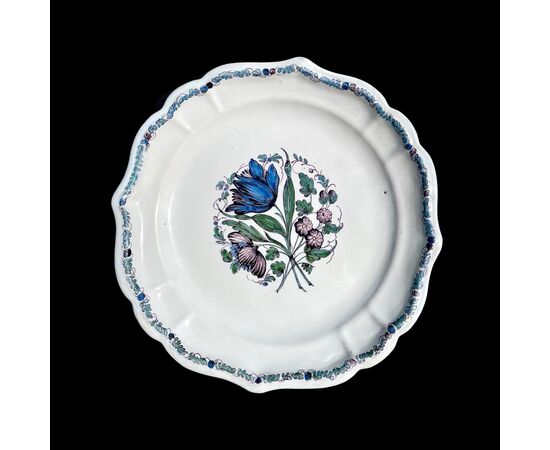 Three majolica plates with lobed brim and floral motif in the cavetto known as &#39;cut flowers&#39;. Antonibon Manufacture, Nove di Bassano.     