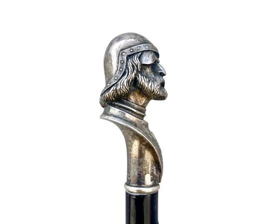 Cane with solid silver knob depicting the head of a crusader with helmet. Ebony barrel with spikes.     