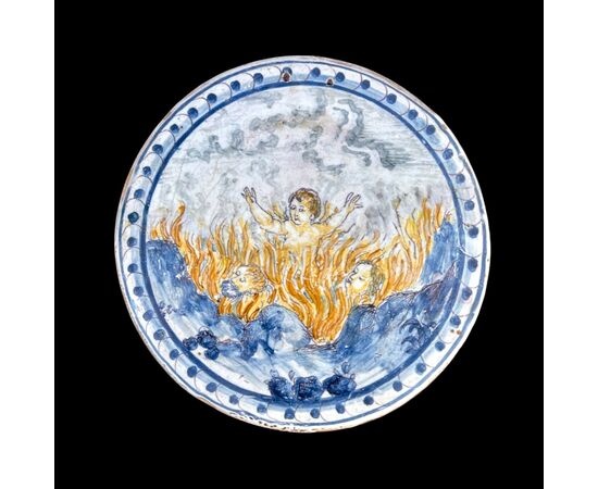 Round tile in majolica decorated with a historiated motif &#39;sinners in hell&#39;.Manufactured by Francesco Vicchi.Faenza.     