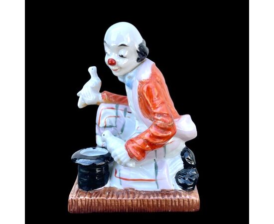 Polychrome porcelain figurine depicting a magician clown. Old Paris. France.     