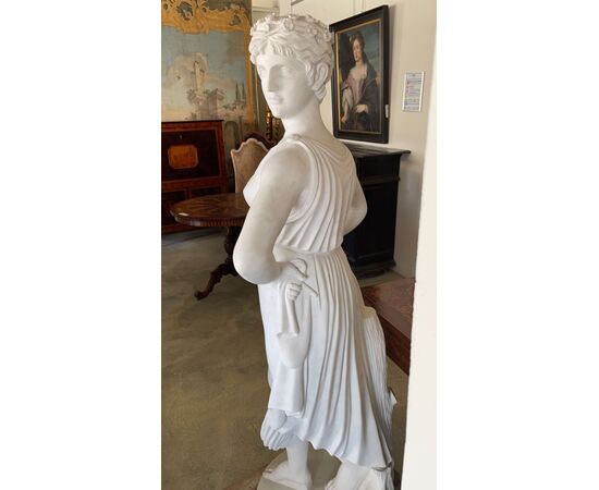 White Carrara marble statue depicting a female figure     