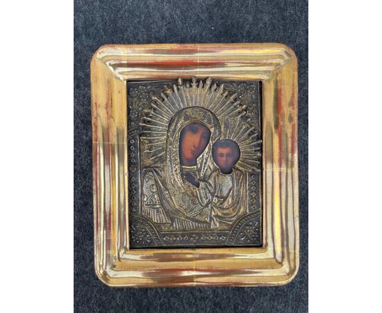 Icon depicting Madonna and Child with painted face and silver foil structure.Russia.     
