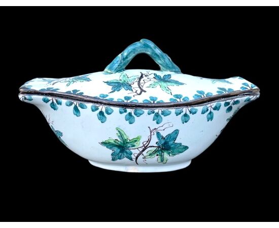 &#39;Boat&#39; majolica gravy boat with twisted branch grip and vine leaf decoration.Ferniani manufacture, Faenza.     