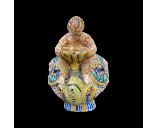 Salt cellar in polychrome majolica with Raphaelesque decoration, plant motifs and masks with a couple of characters holding shells.Molaroni manufacture.Pesaro     