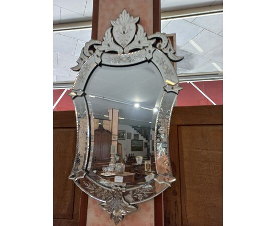Venetian mirror with floral decoration.     