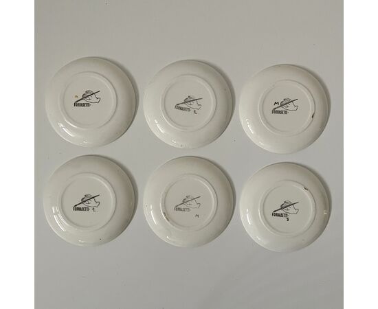FORNASETTI, six under Manneken Bis saucers, painted ceramic     
